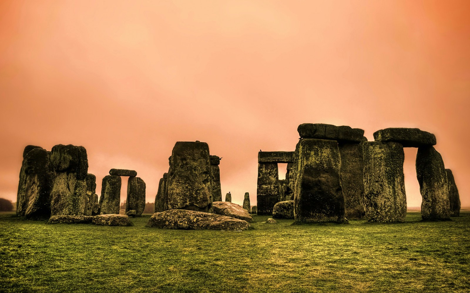 Stonehenge stone circle under an orange sky, part of Salisbury and Avebury tour.
