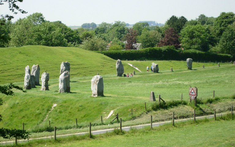 Avebury stone circle in a grassy landscape, part of the Stonehenge, Glastonbury, and Avebury Tour.