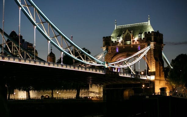 Tower Bridge illuminated at night during Thames Jazz Cruise, London.