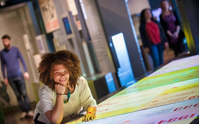 Visitor exploring interactive exhibit at Churchill War Rooms, London.