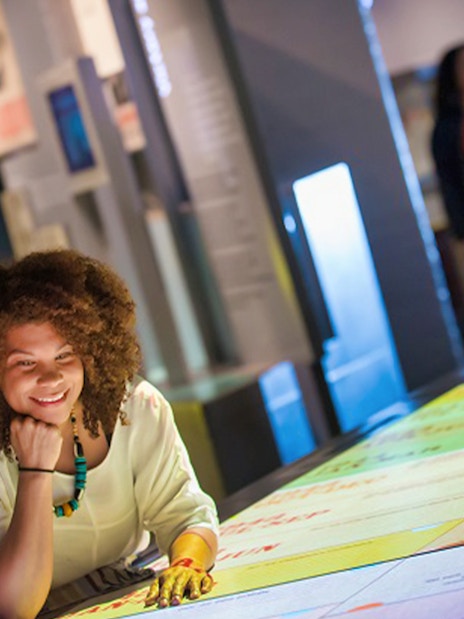 Visitor exploring interactive exhibit at Churchill War Rooms, London.