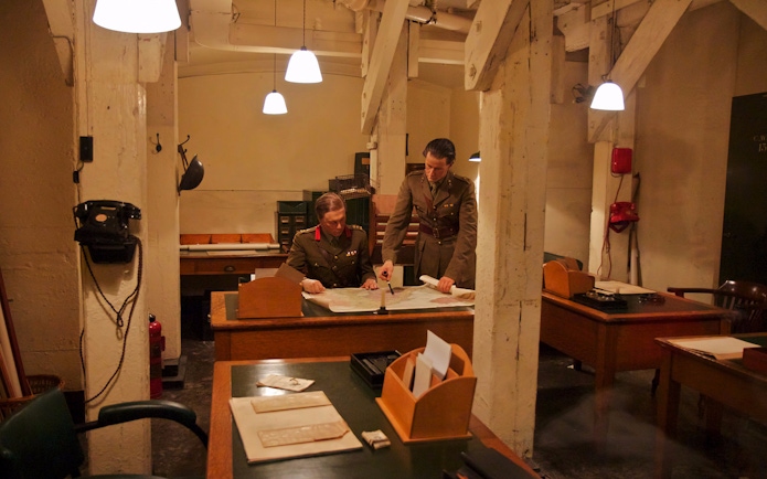 Two military officers examining a map in the Churchill War Rooms, London.
