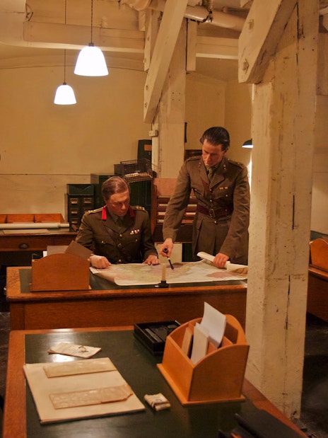 Two military officers examining a map in the Churchill War Rooms, London.