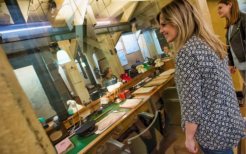 Visitors observing the historic Churchill War Rooms in London.