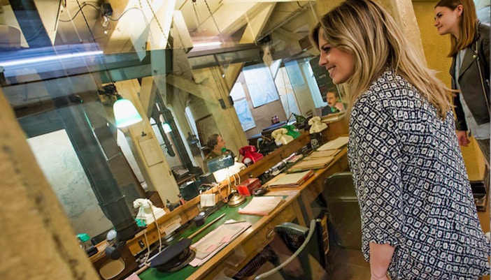 Visitors observing the historic Churchill War Rooms in London.