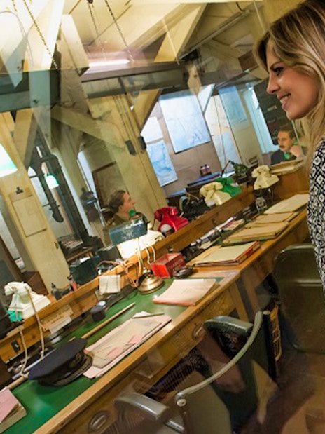 Visitors observing the historic Churchill War Rooms in London.