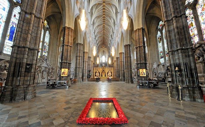 Westminster Abbey interior with ornate arches and stained glass windows, London.