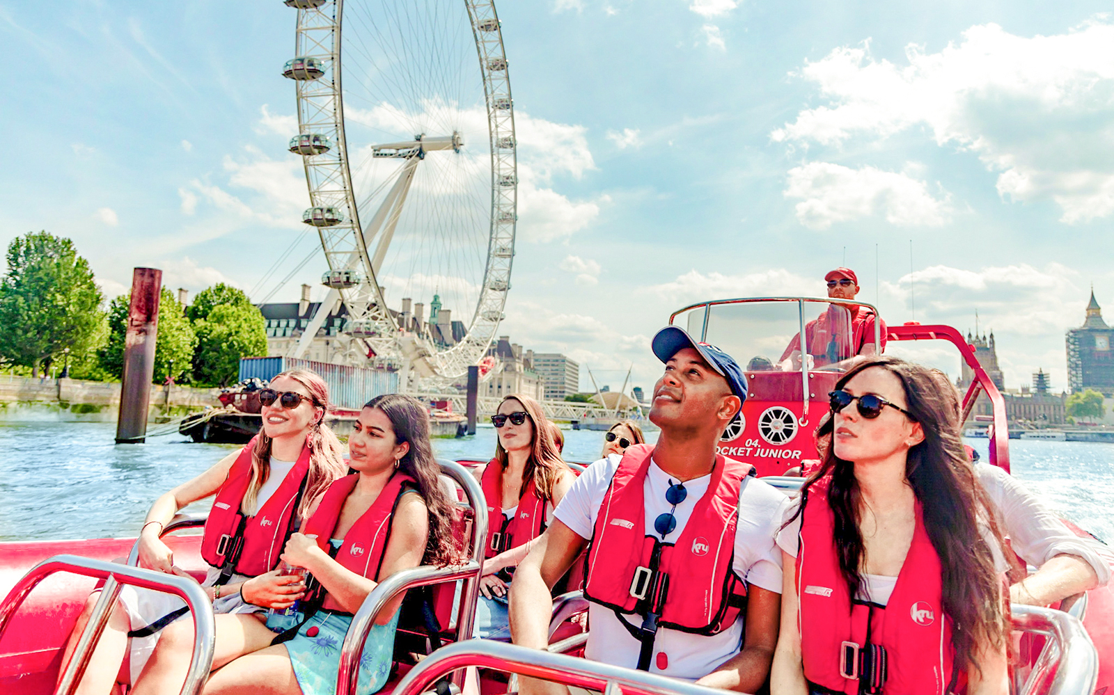 People enjoying a Thames Rockets high-speed boat ride with the London Eye in the background.