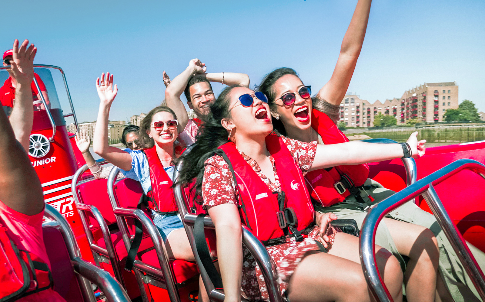 Group enjoying Thames Rockets high-speed boat ride on the River Thames, London.