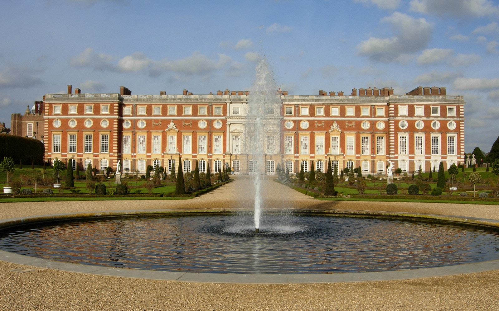 Hampton Court Palace with fountain in foreground on private tour.