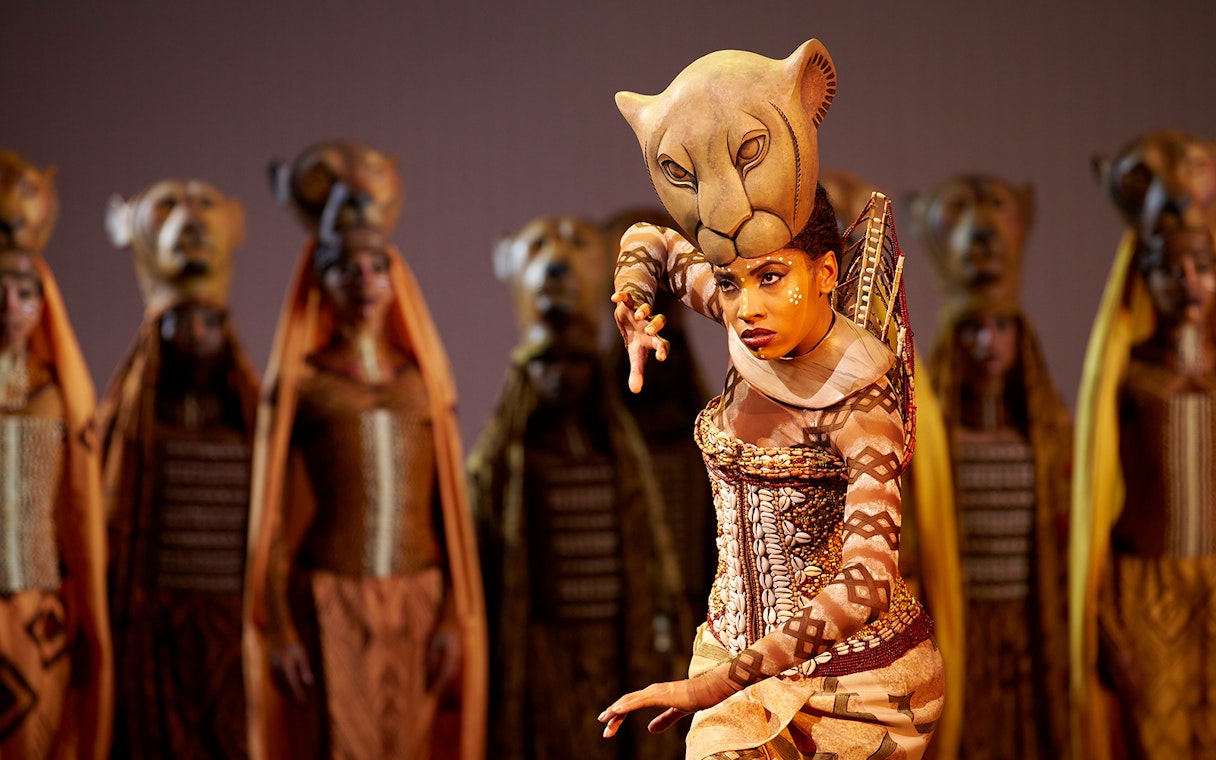 Performer in lioness costume during The Lion King West End show.