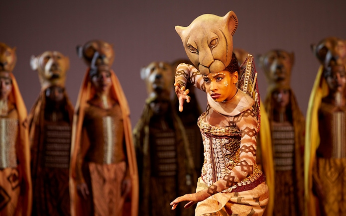 Performer in lioness costume during The Lion King West End show.