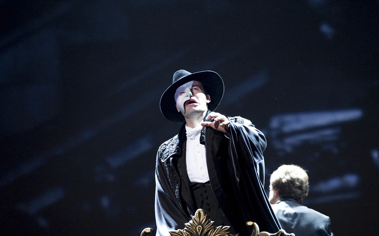 Performer in Phantom of the Opera costume on stage.