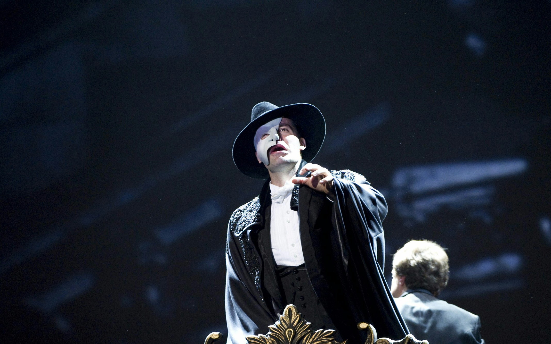 Performer in Phantom of the Opera costume on stage.