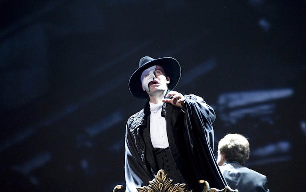 Performer in Phantom of the Opera costume on stage.