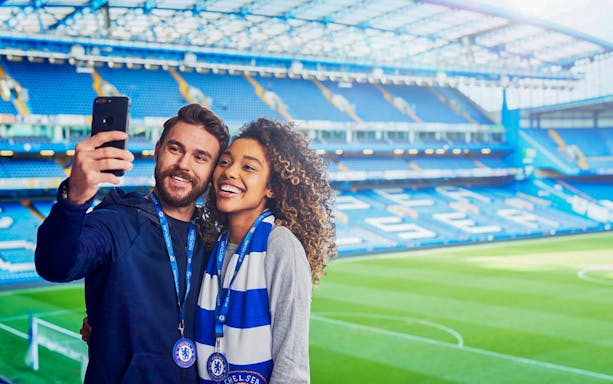 Tourists taking a selfie at Chelsea FC Stadium in London.