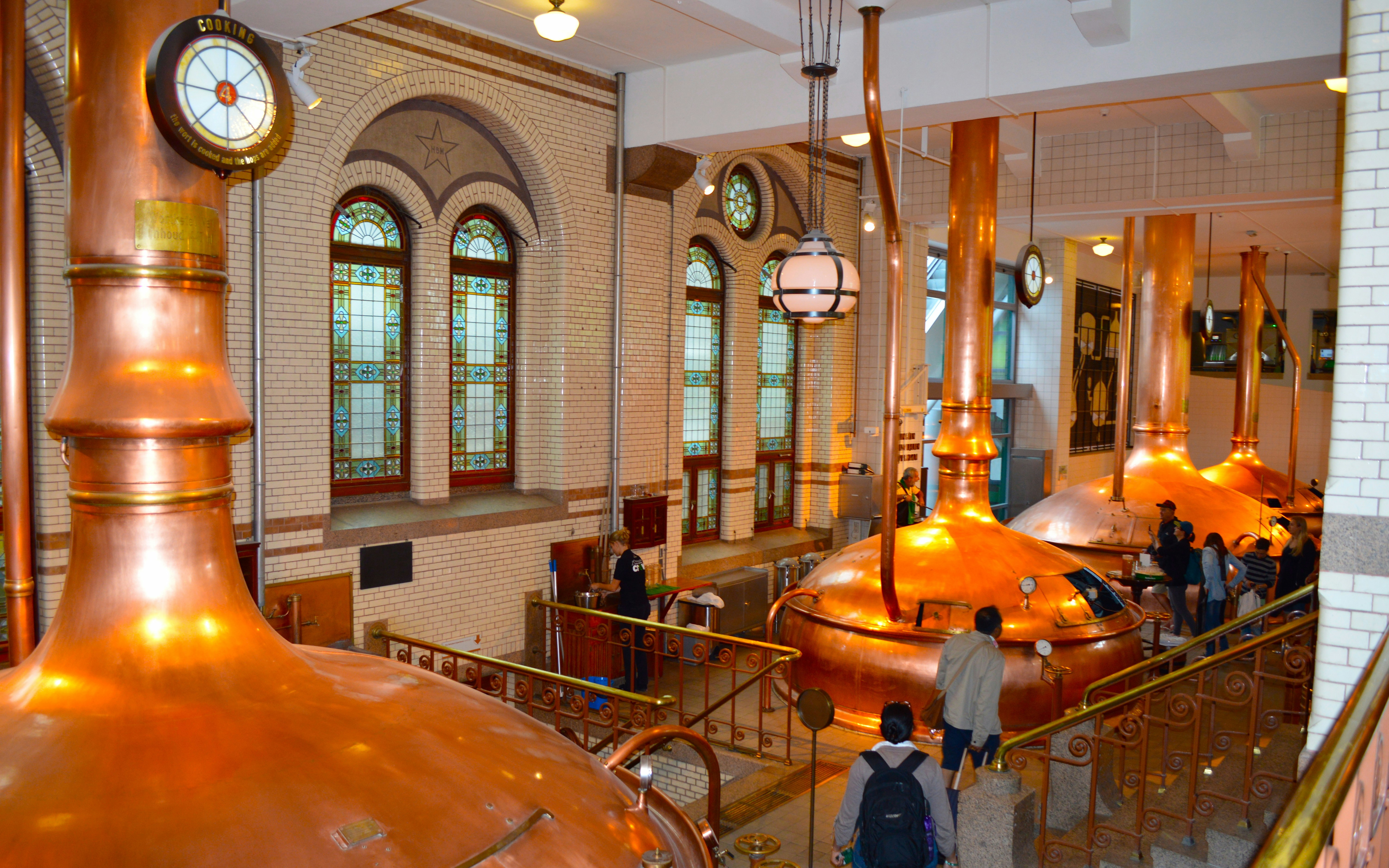 Heineken Experience entrance in Amsterdam with visitors entering the historic brewery.