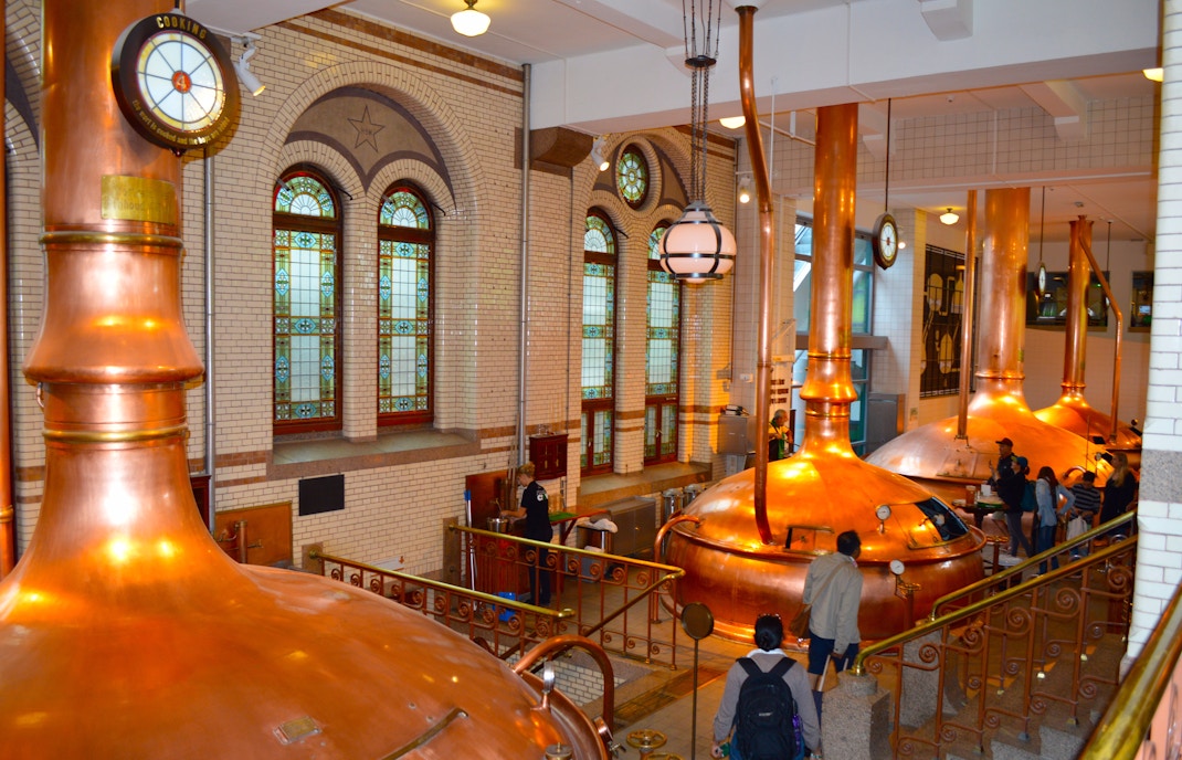 Heineken Experience entrance in Amsterdam with visitors entering the historic brewery.
