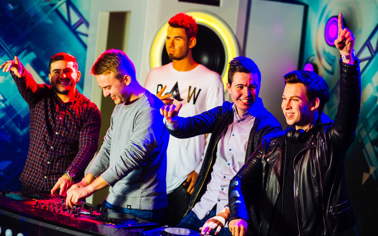 Group enjoying DJ experience at Madame Tussauds Amsterdam.