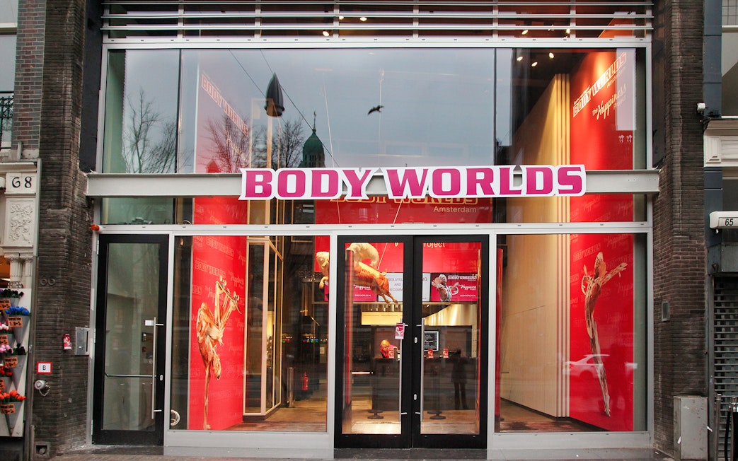 Body Worlds Amsterdam entrance with anatomical displays inside.