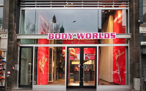Body Worlds Amsterdam entrance with anatomical displays inside.