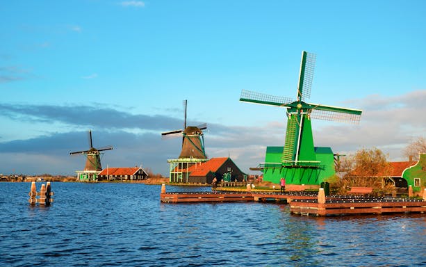 Windmills along the water at Zaanse Schans during a half-day trip.