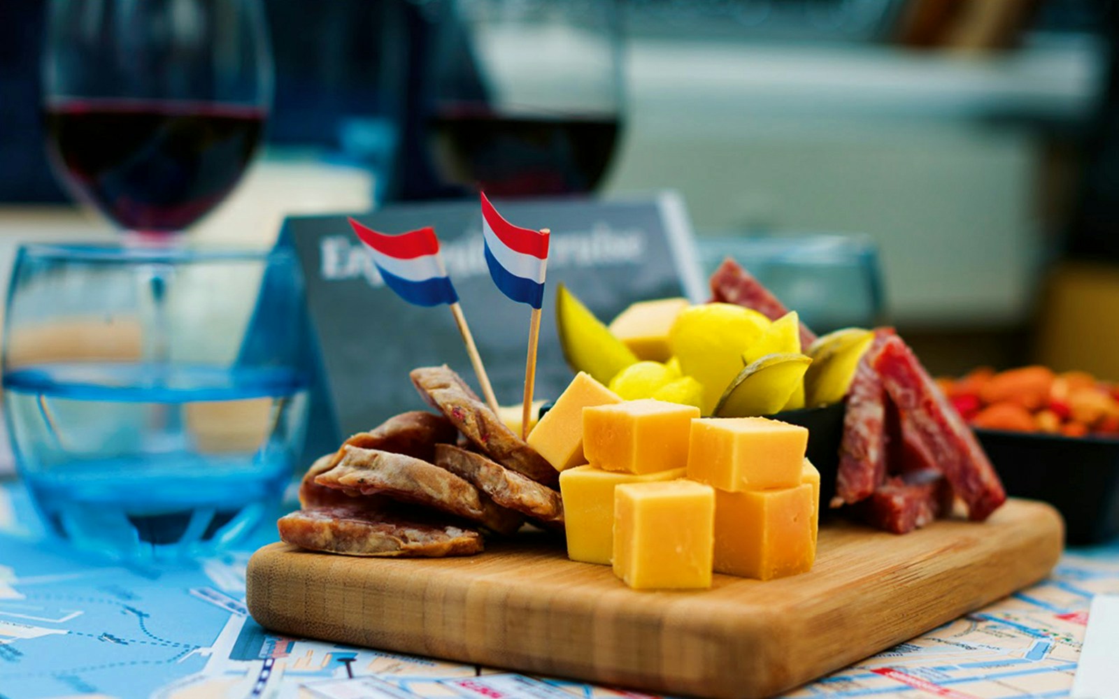Dutch wine and cheese platter with flags on a cruise table.