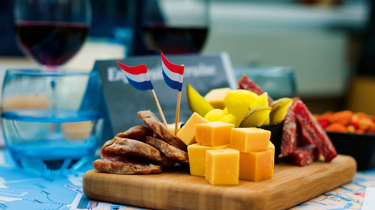 Dutch wine and cheese platter with flags on a cruise table.