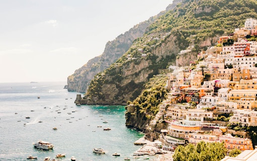 Cliffside village and boats along the Amalfi Coast, Italy.