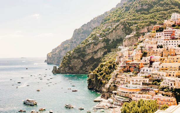Cliffside village and boats along the Amalfi Coast, Italy.