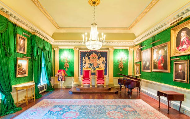 Throne room with red chairs and portraits at Hillsborough Castle and Gardens.
