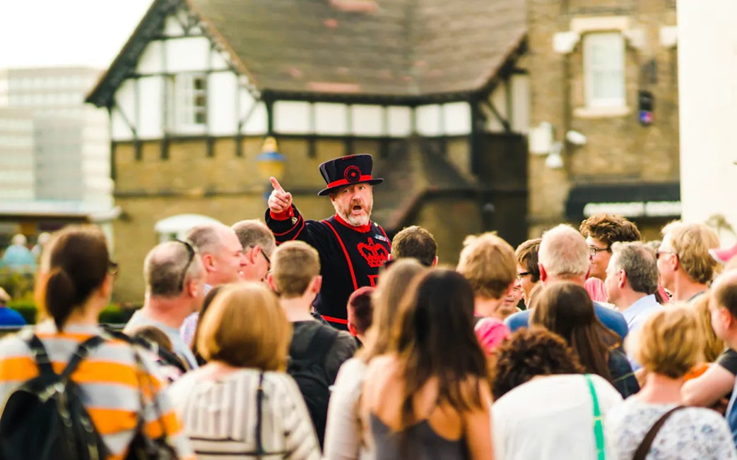 Beefeater guiding tourists at the Tower of London.