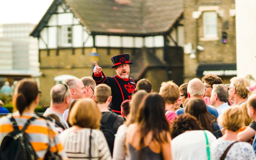 Beefeater guiding tourists at the Tower of London.