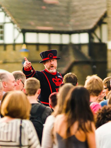 Beefeater guiding tourists at the Tower of London.