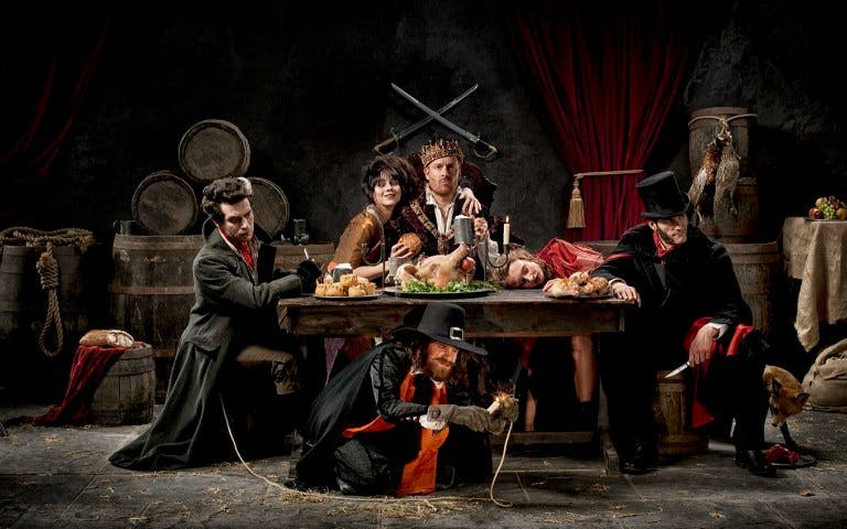 Characters in historical costumes at a medieval feast, part of The London Bridge Experience.