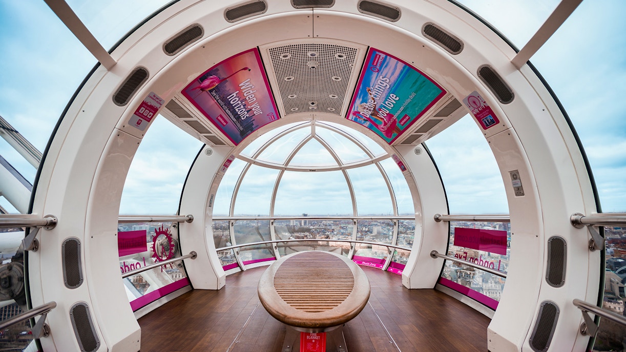 London Eye capsule interior with city view through glass windows.