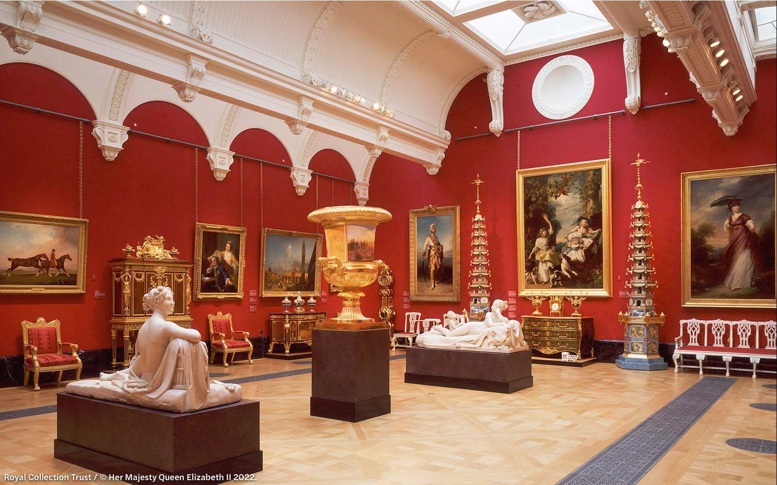 Interior of The Queen's Gallery at Buckingham Palace with classical sculptures and paintings.
