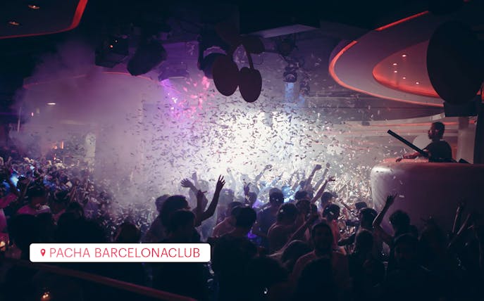 Crowd dancing at Pacha Barcelona club with confetti falling.