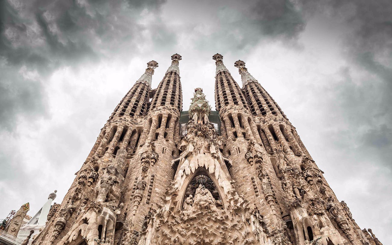 Sagrada Familia facade with intricate sculptures, Barcelona, part of guided tour.