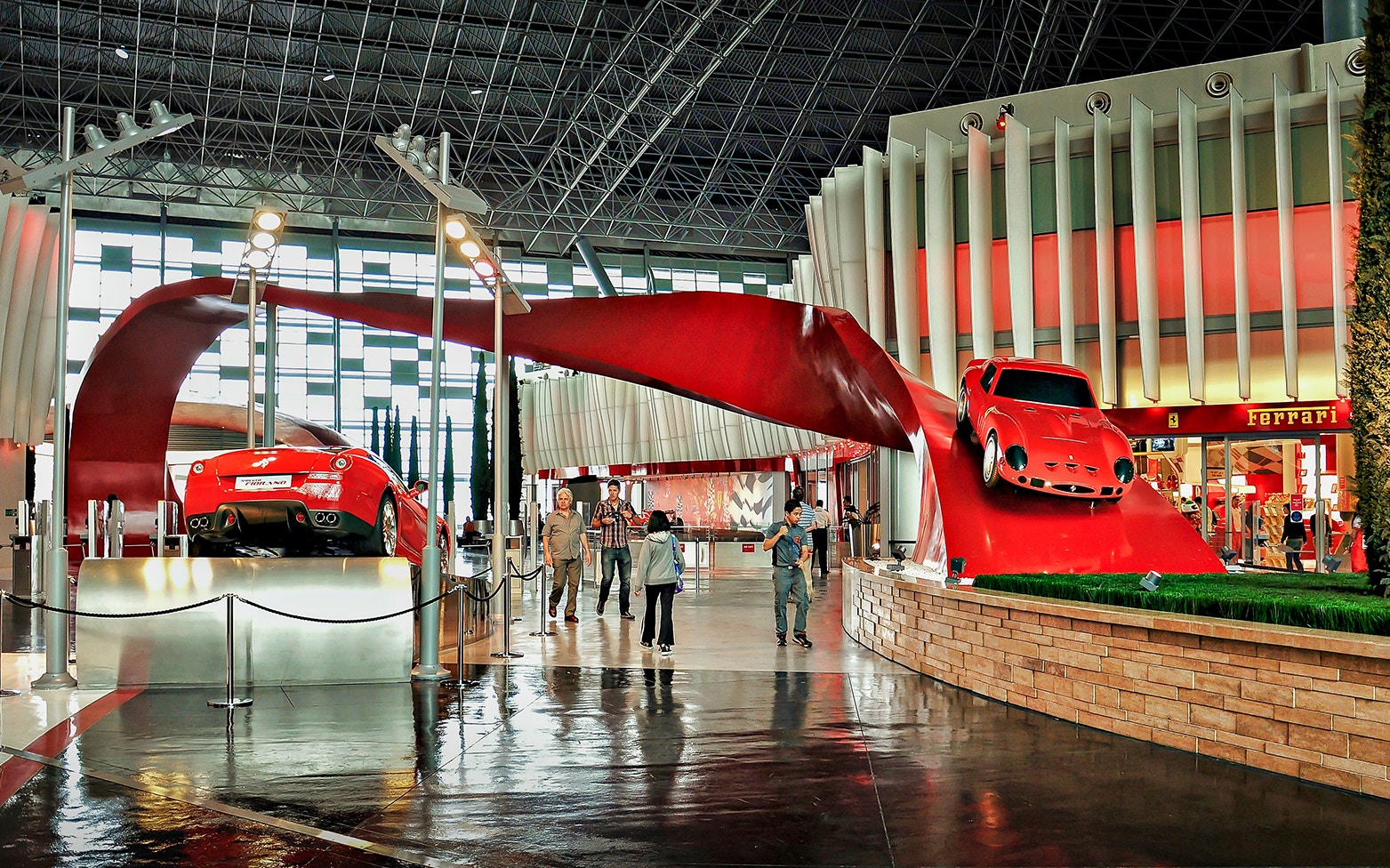 Ferrari World interior with red cars and visitors, Abu Dhabi City Tour.