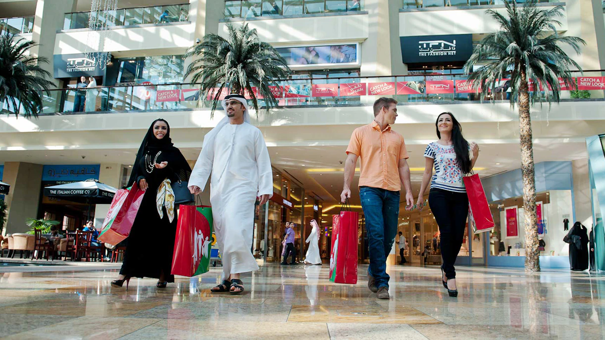 Shoppers walking in a Dubai mall during a half-day shopping tour.