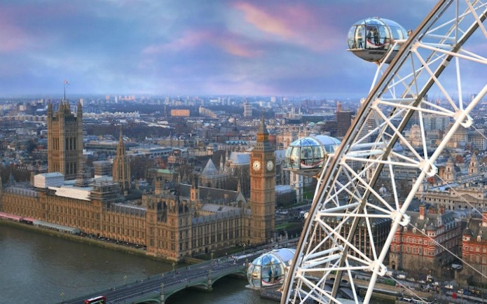 London Eye overlooking Big Ben and Houses of Parliament at sunset.