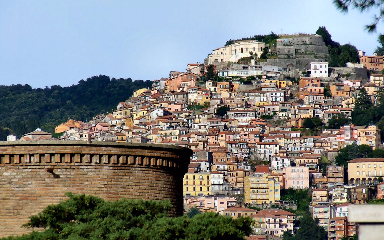 Hillside view of colorful buildings in Castelli Romani, Italy.