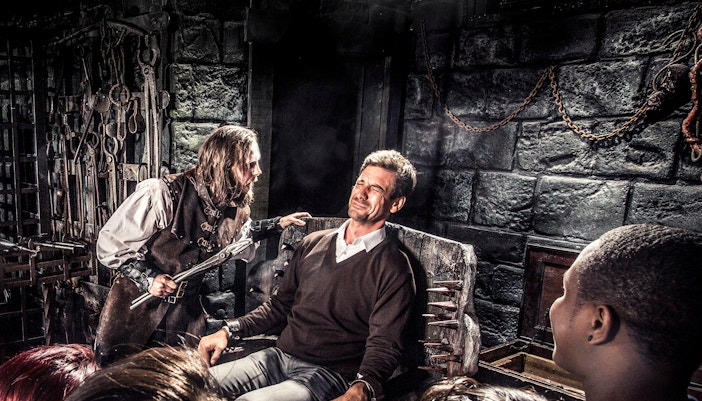 Man in medieval torture scene at Amsterdam Dungeon, part of Skip The Line Combo tour.