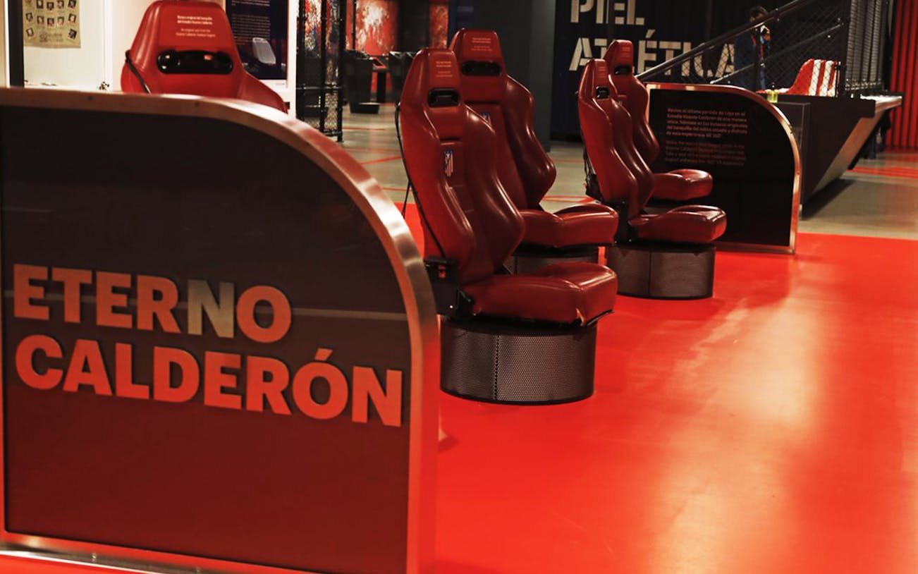 Red stadium seats at Cívitas Metropolitano Stadium Museum with "Eterno Calderón" sign.