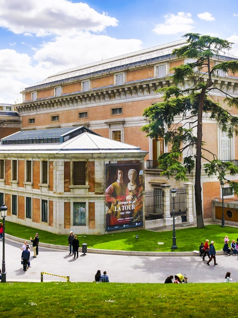 Prado Museum exterior with visitors in Madrid, Spain.
