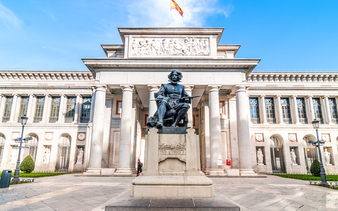 Prado Museum entrance with Velázquez statue in Madrid, Spain.