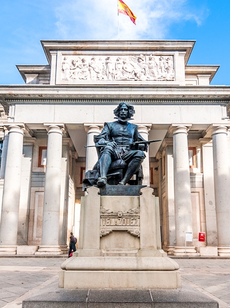 Prado Museum entrance with Velázquez statue in Madrid, Spain.