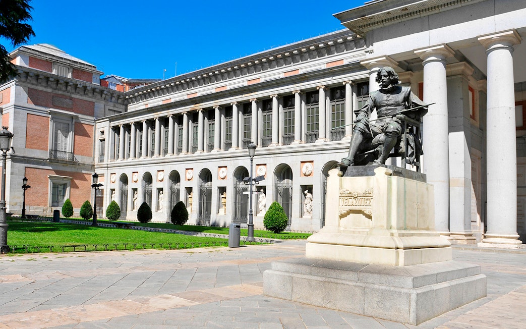 Prado Museum entrance with Velázquez statue in Madrid.