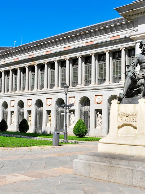 Prado Museum entrance with Velázquez statue in Madrid.